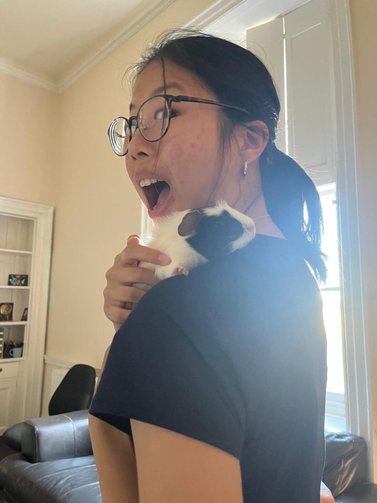 A female Langley boarder with a hamster on her shoulder